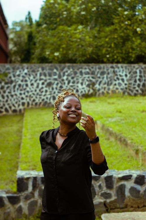 Free Smiling woman enjoying a sunny day outdoors in a garden. Stock Photo