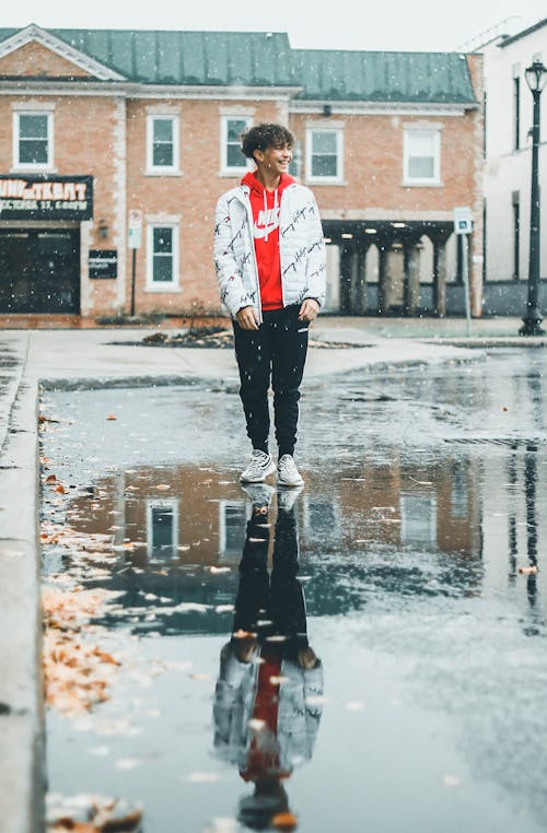 Man Standing on Wet Road