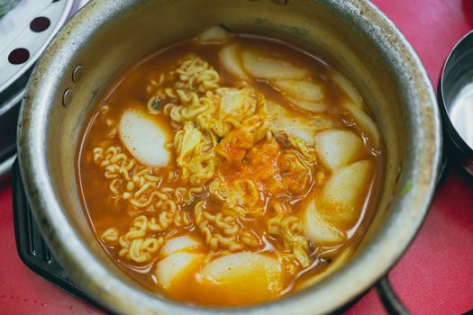 Savory Korean tteokbokki with ramen in a hot and spicy broth, perfect for food lovers.