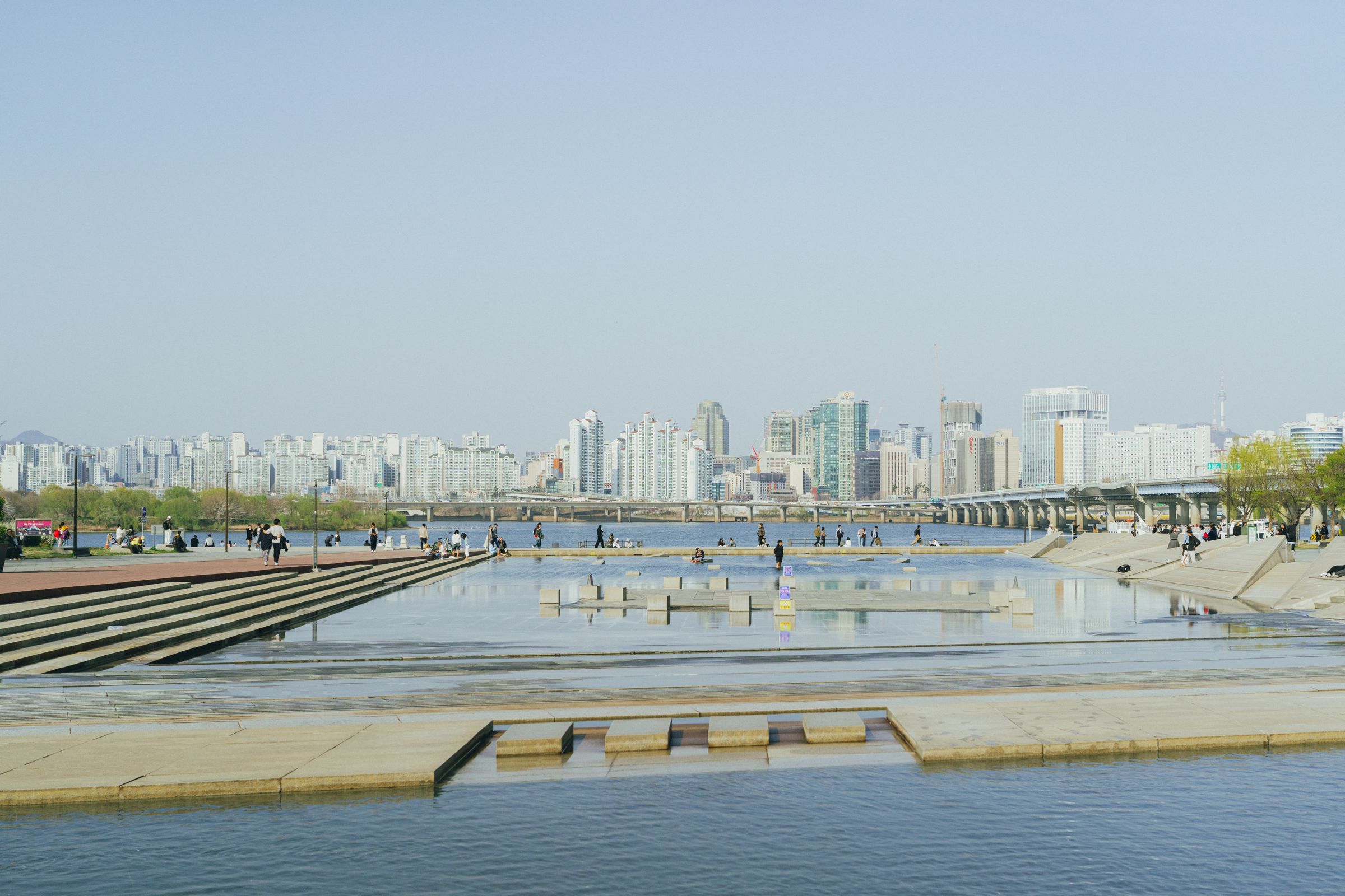 People relaxing on a summer evening at Yeouido Hangang Park