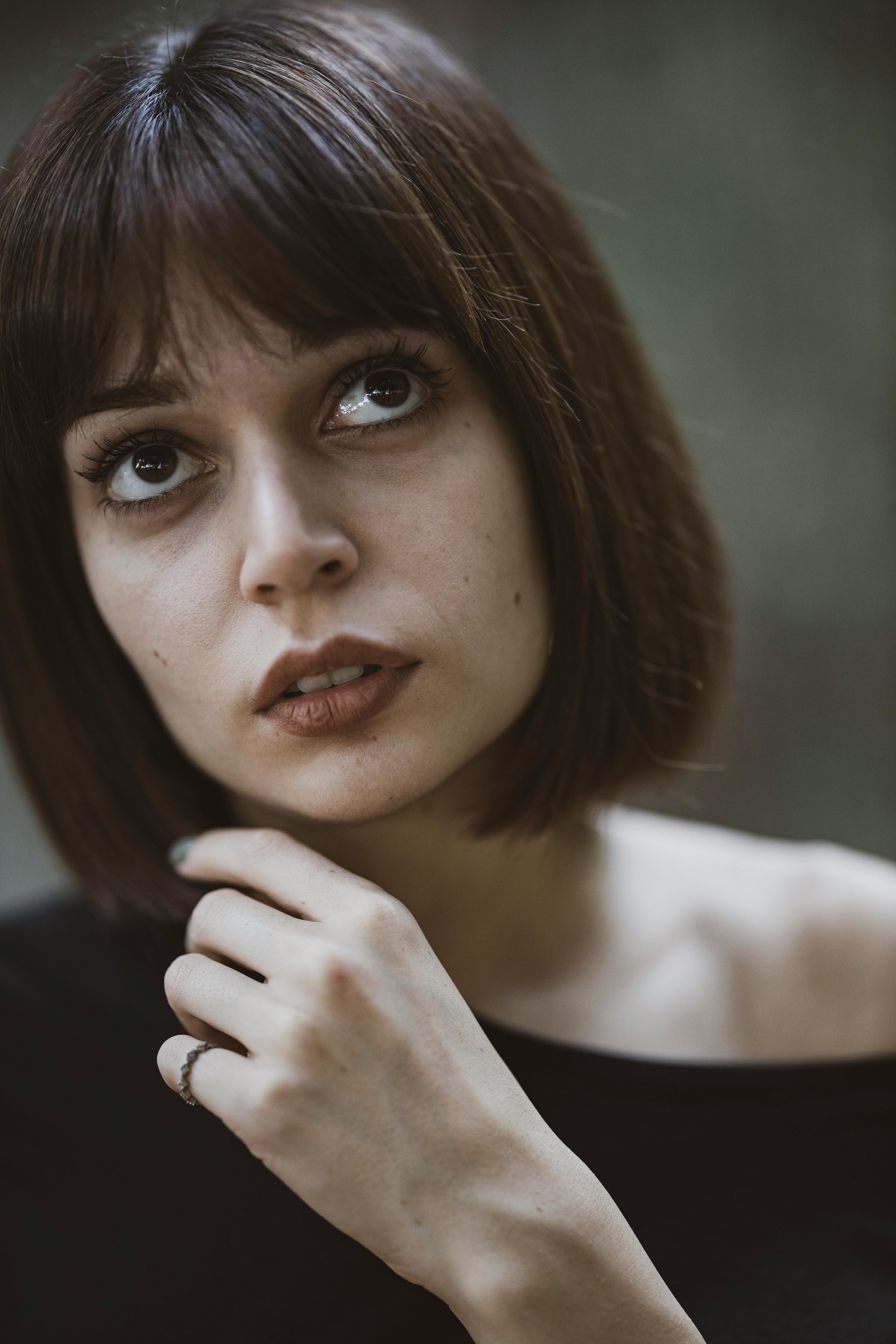 woman in black top daydreaming