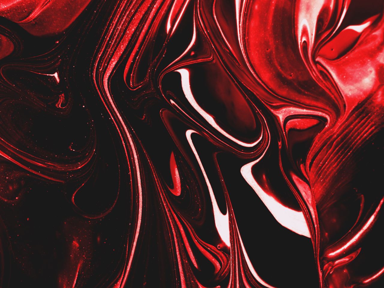 dynamic swirls of red and black create a striking abstract pattern in