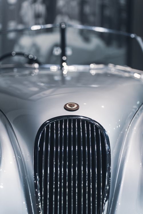 Free Elegant close-up view of a classic retro car grille with a shiny chrome finish. Stock Photo