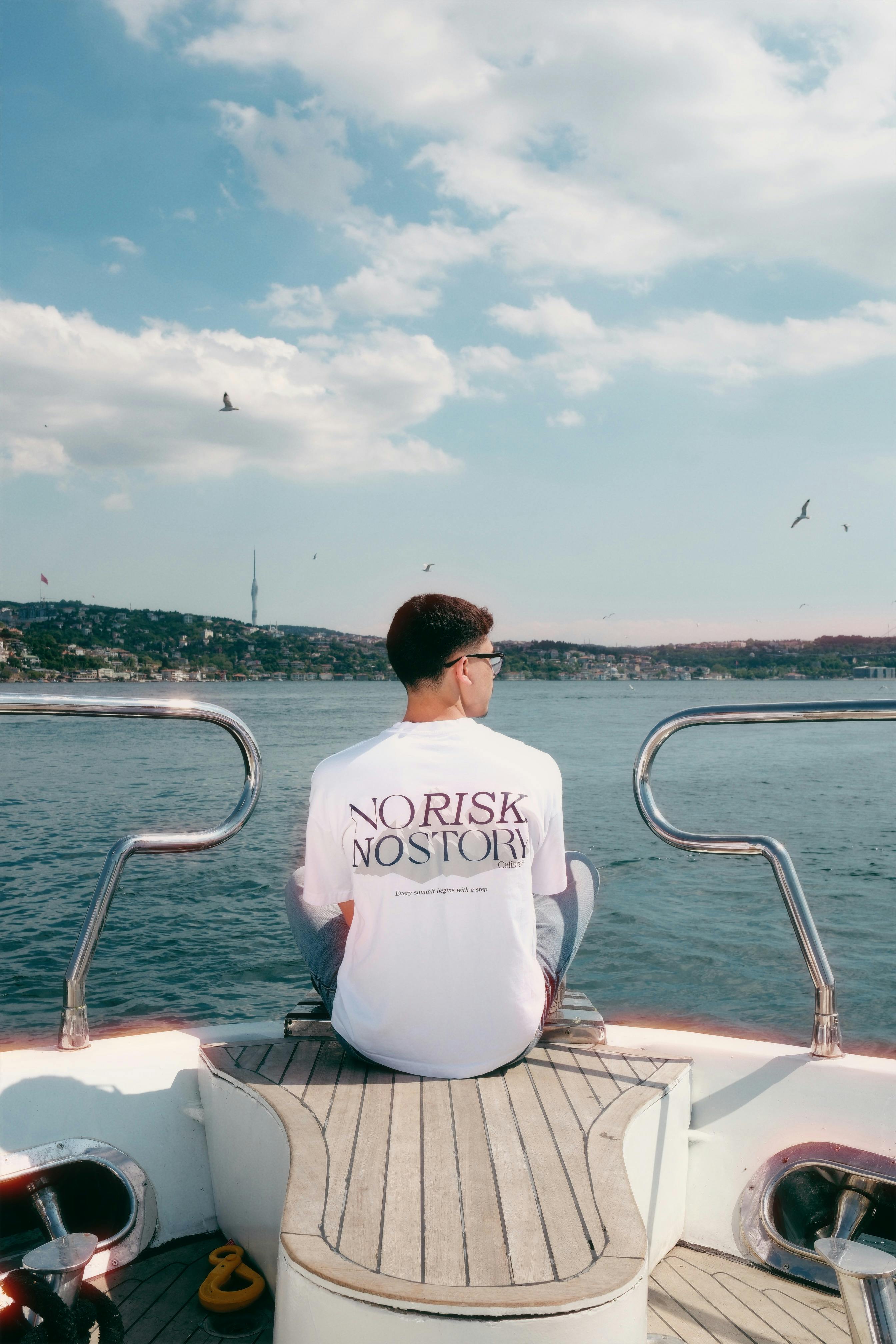 Man sitting on a boat enjoying the view of the Bosphorus in İstanbul, Türkiye.