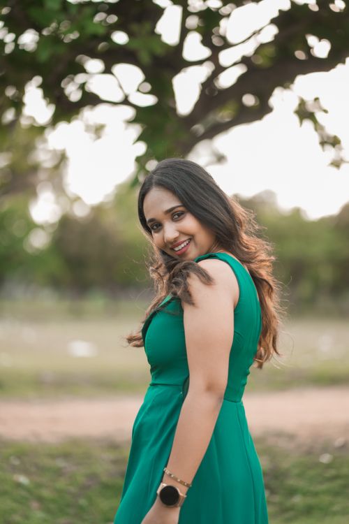 Smiling Woman in Green Dress Outdoors · Free Stock Photo
