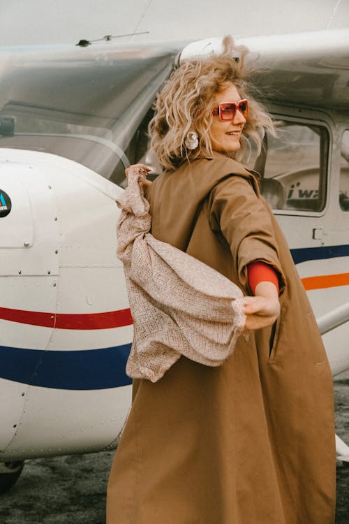 Photo Of Woman Standing Beside Aeroplane