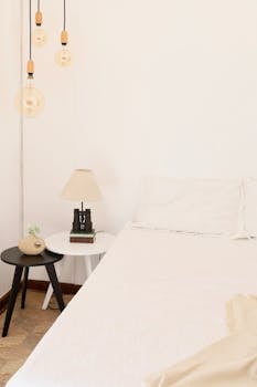 Calm minimalist bedroom showcasing elegant design and soft lighting.