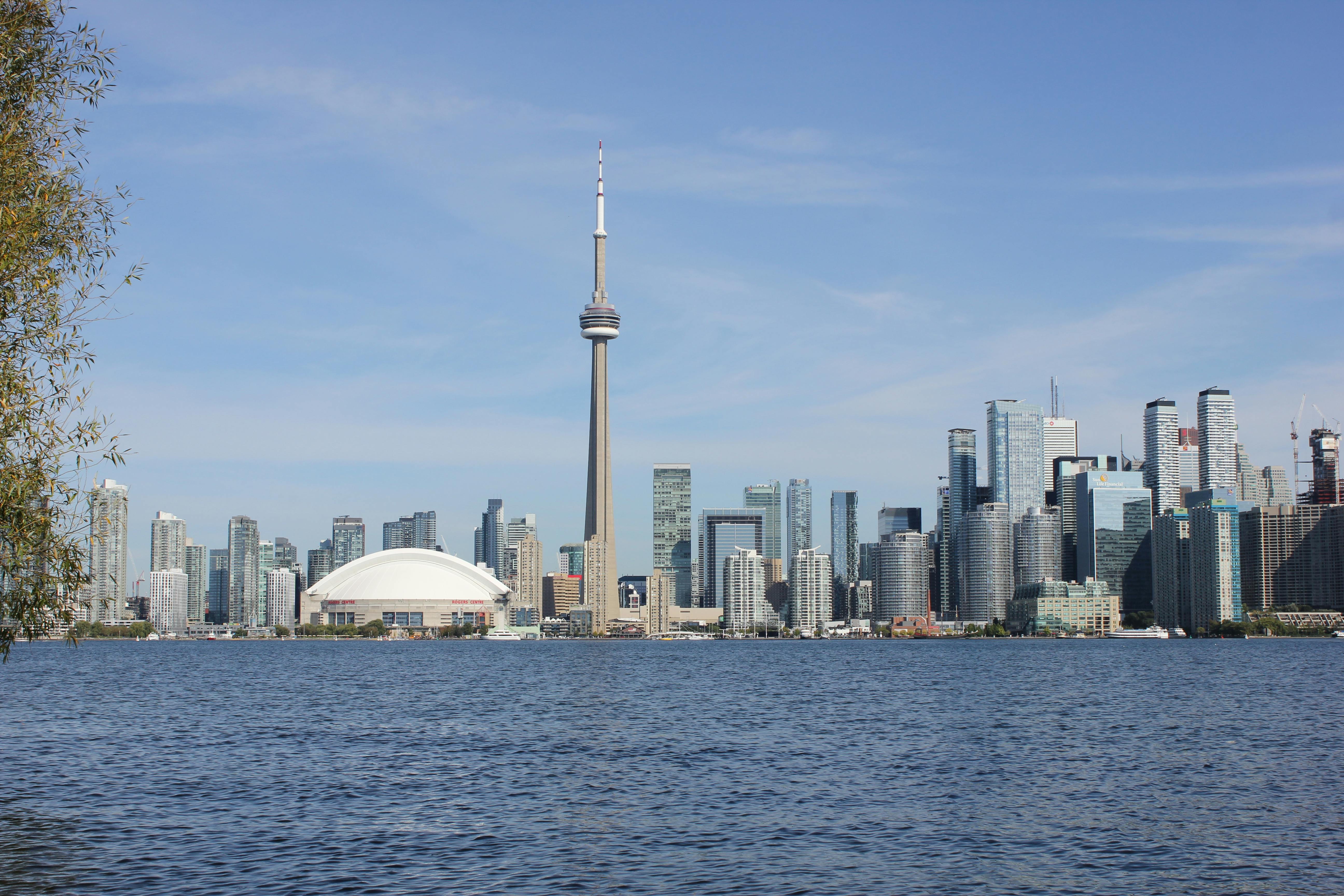 A stunning view of Toronto's skyline with the CN Tower on a sunny day. - Toronto