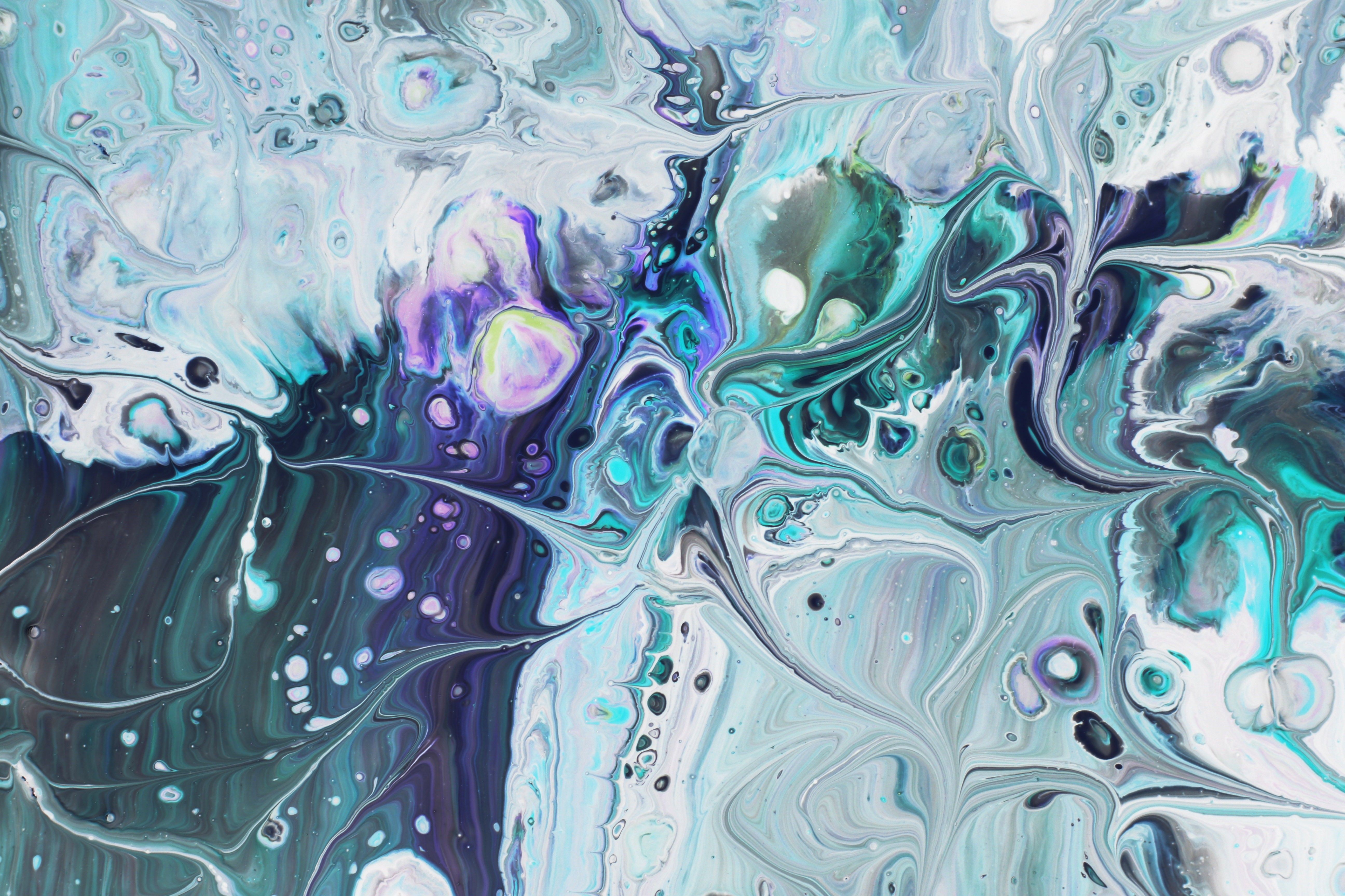 Colorful abstract acrylic pour featuring swirling patterns and mixed hues.
