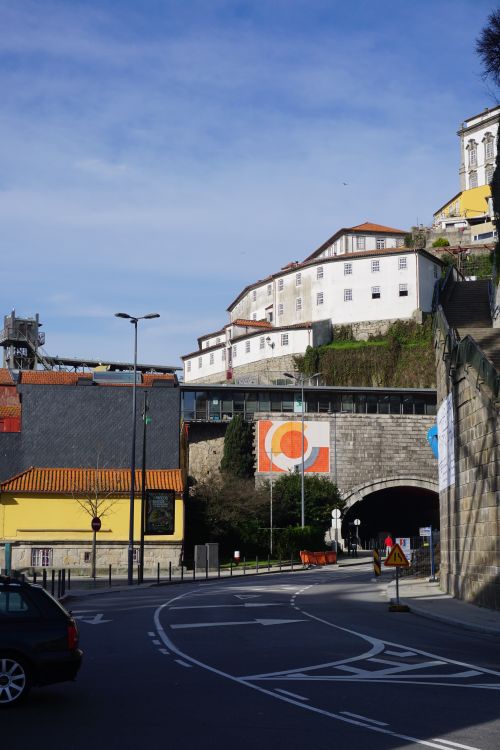 Free A street scene in Porto, Portugal featuring vibrant architecture and a tunnel entrance. Stock Photo