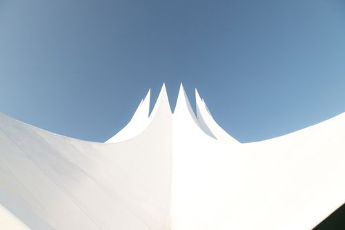 Free A captivating view of the Tempodrom's modern structure against the blue sky in Berlin, Germany. Stock Photo
