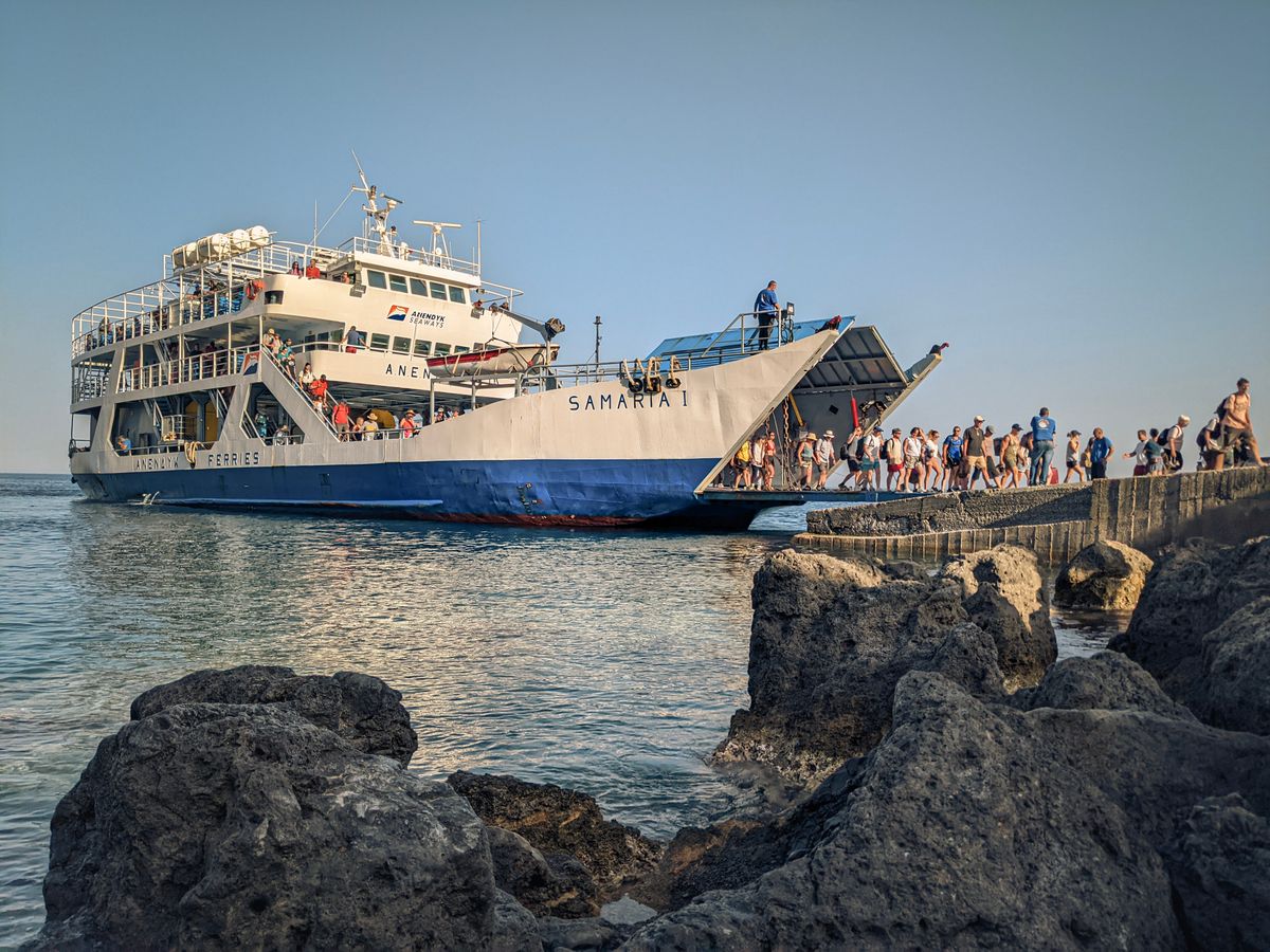 Passengers disembarking a ferry at a dock