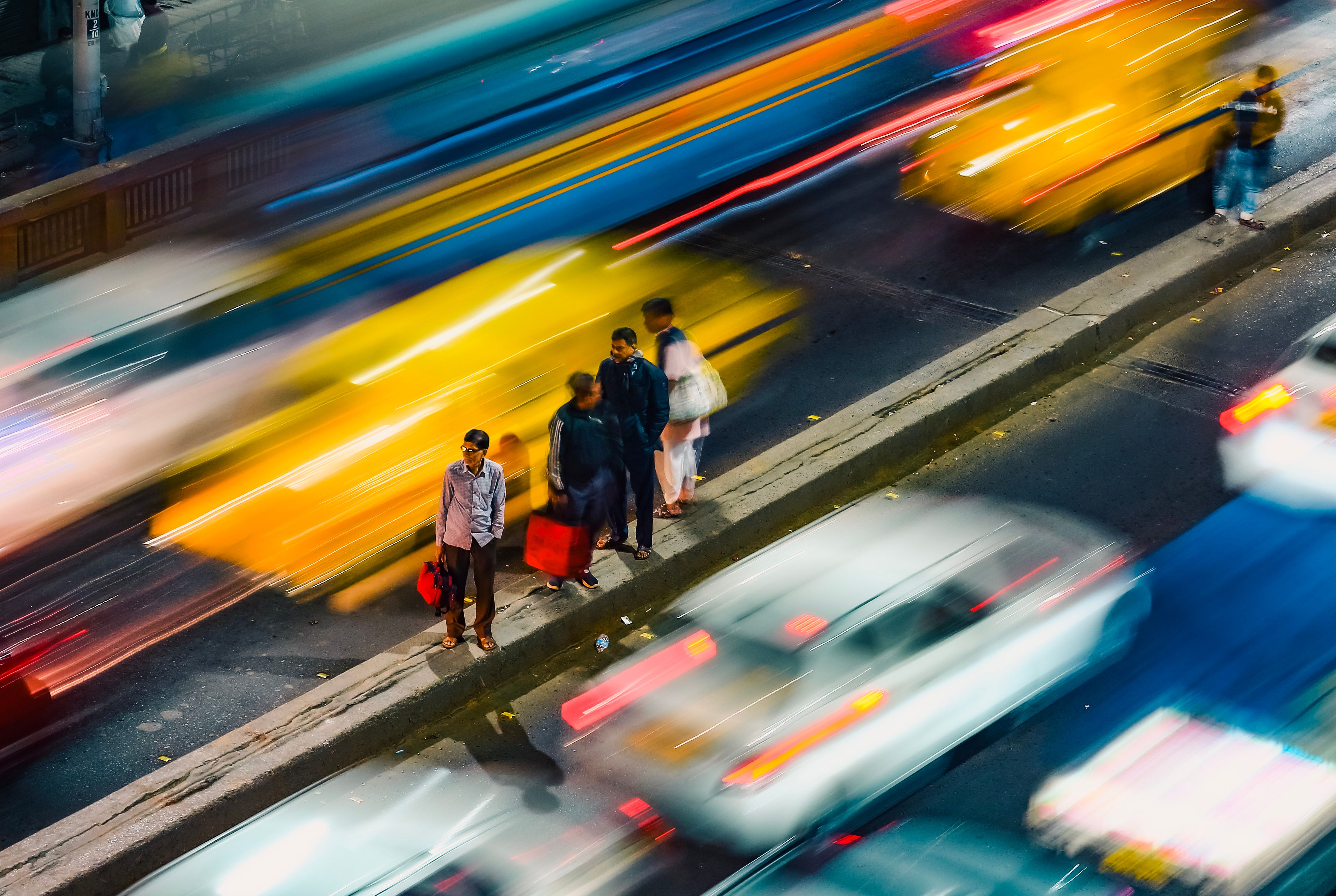Motion-blurred evening traffic on a crowded Kolkata street