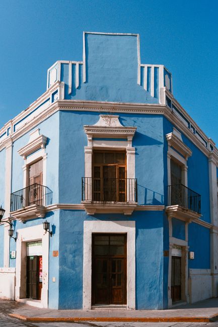 Vibrant blue colonial building in San Francisco de Campeche under clear sky, showcasing beautiful architecture.
