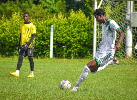 Soccer player in action on a grassy field, showcasing skill and determination.