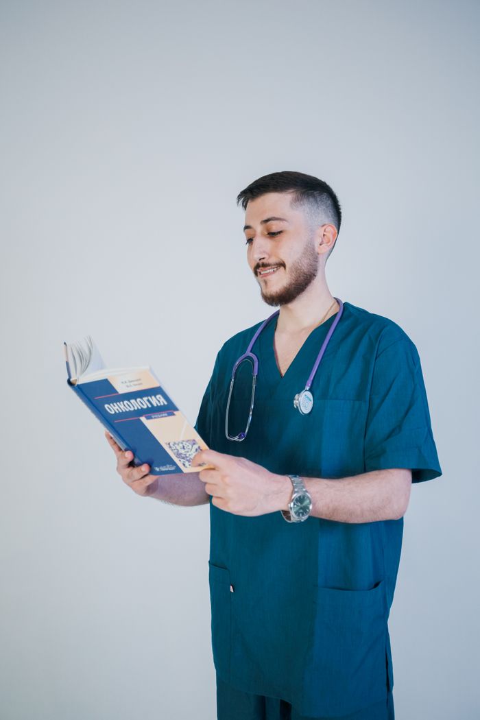 Postgraduate healthcare student reading a medical textbook