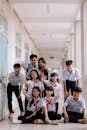 Cheerful Group of Students Posing in School Corridor