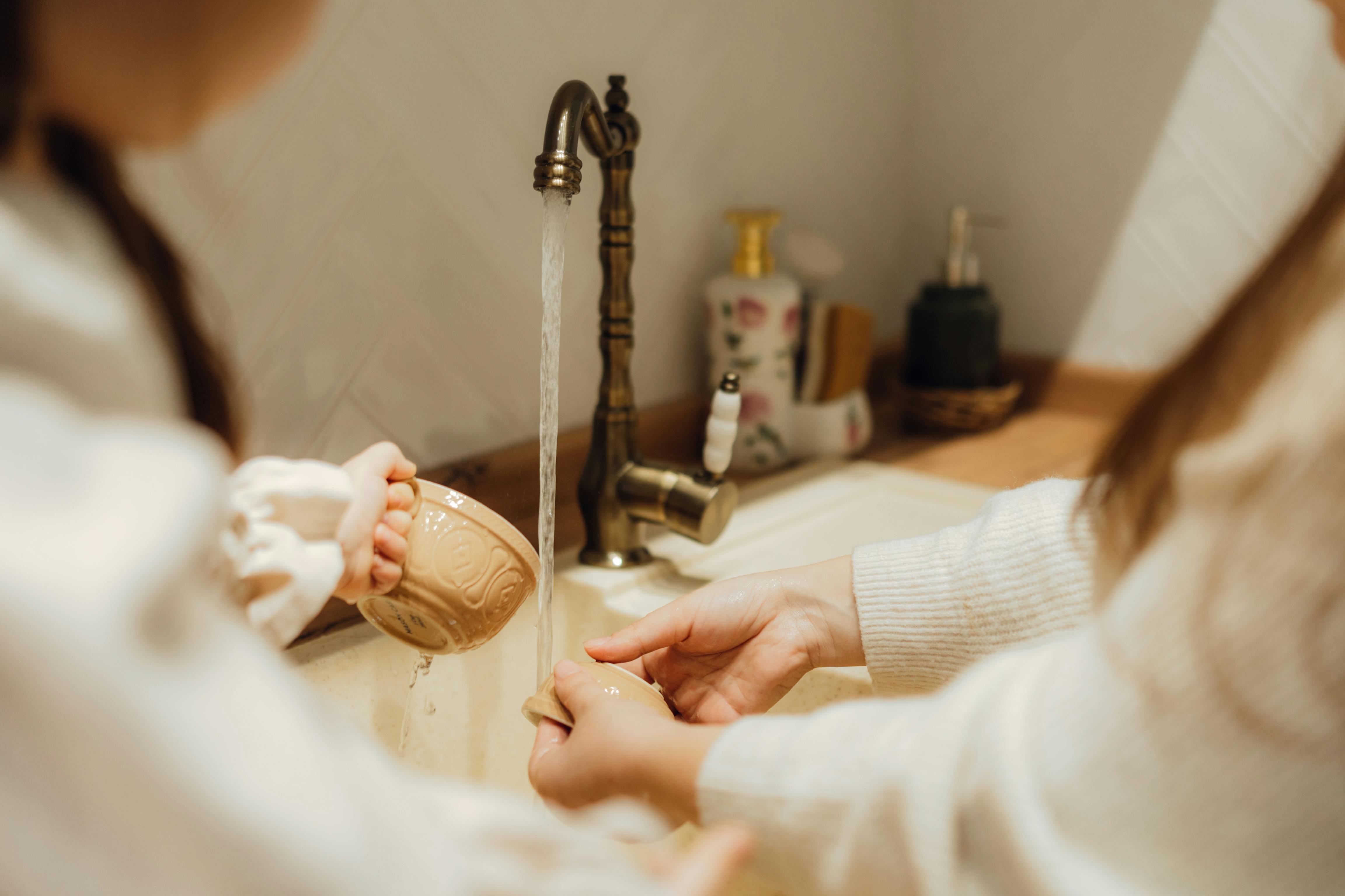 family enjoying clean water from kitchen tap - whole home water filtration in oxnard ca