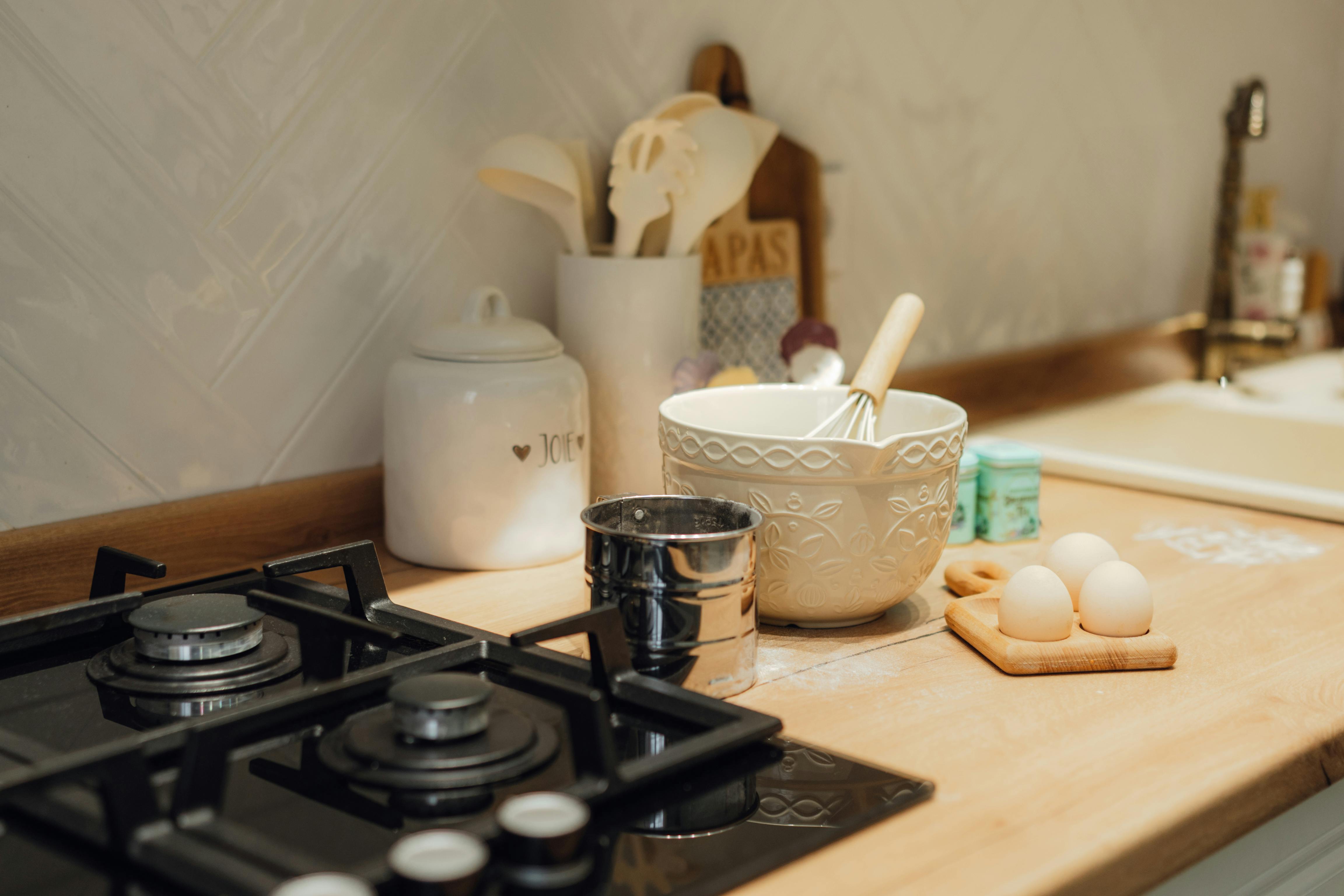 Well-organized kitchen with Chinese cooking essentials: wok, bamboo steamer, and jars of spices