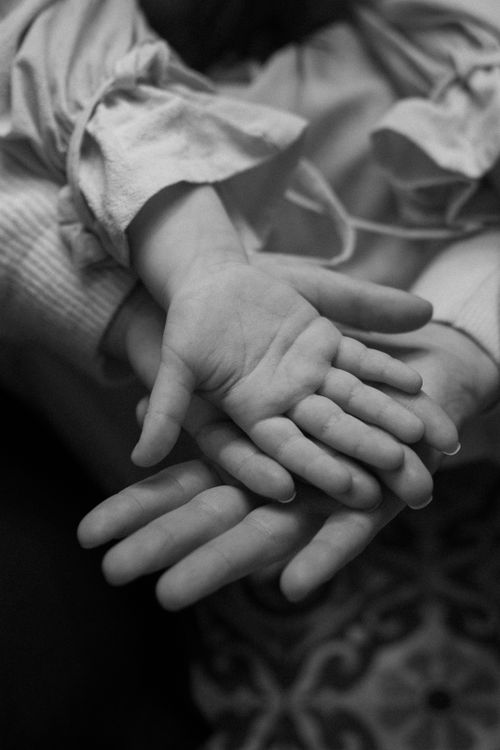 Free Black and white photo of family hands symbolizing love and connection. Stock Photo