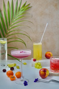 Vibrant summer cocktails with fresh fruits and palm leaves creating a tropical vibe.