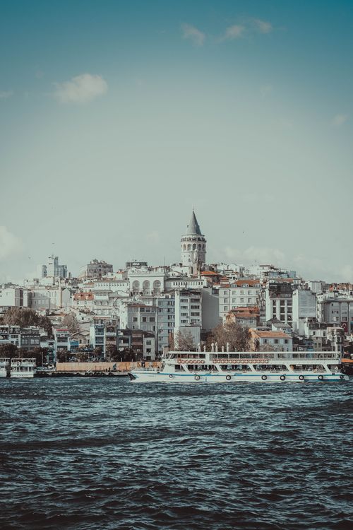 Free Beautiful view of Istanbul's skyline featuring Galata Tower and ferry on Bosphorus. Stock Photo