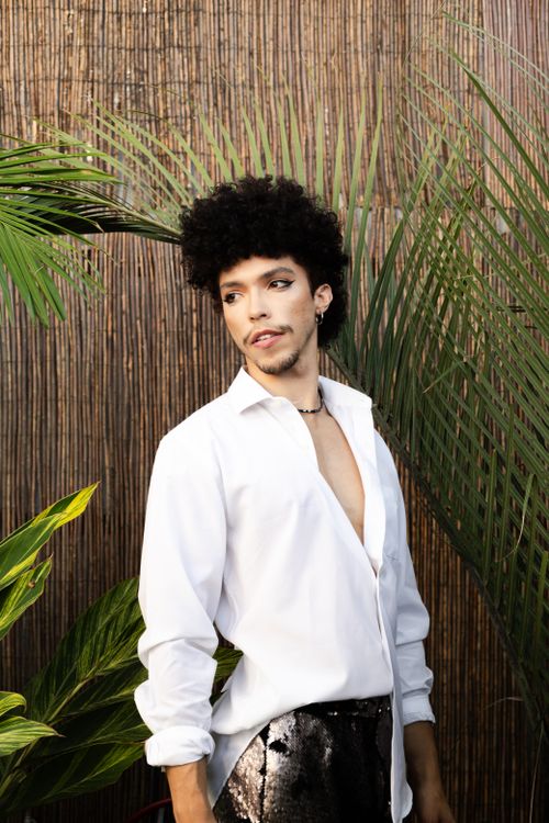 Free Elegant portrait of a person in a white shirt surrounded by tropical plants, São Paulo. Stock Photo