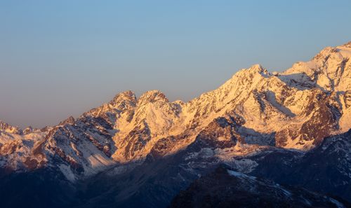 Free A stunning view of snowy peaks in Lanzada, Italy, illuminated by sunrise. Stock Photo