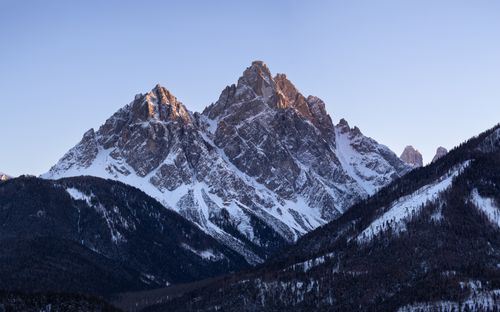 Free Breathtaking view of the majestic Dolomites in Italy, showcasing snow-capped peaks under a clear blue sky. Stock Photo