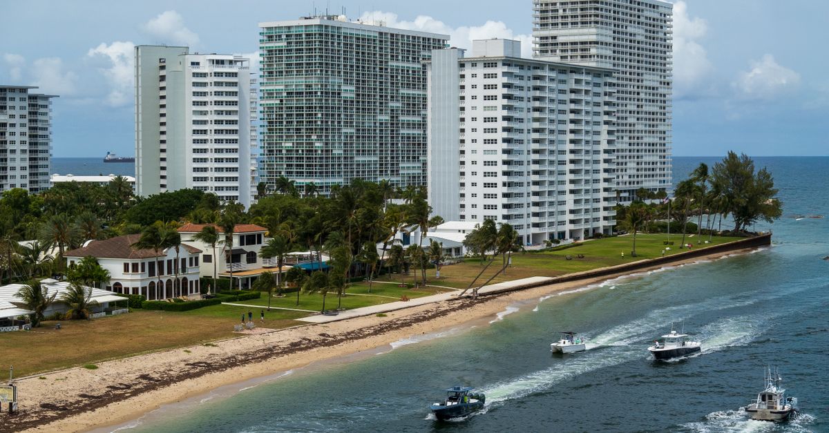 Aerial view of Fort Lauderdale high-rise buildings along the beach with boats on the water, exemplifying coastal city life.