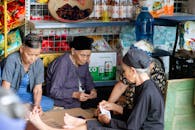 Elderly Women Playing Cards in Vietnamese Market