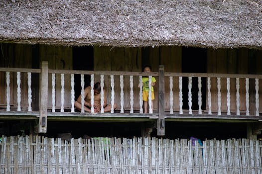 A traditional stilt house in Hà Giang, Vietnam, showcasing a local family in a serene rural setting.
