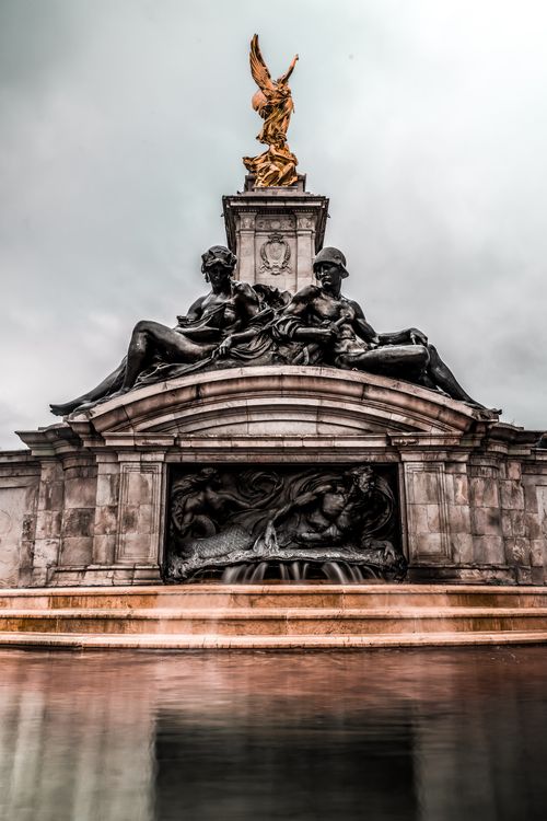 Free Stunning low angle view of the Victoria Memorial fountain with intricate sculptures in London. Stock Photo