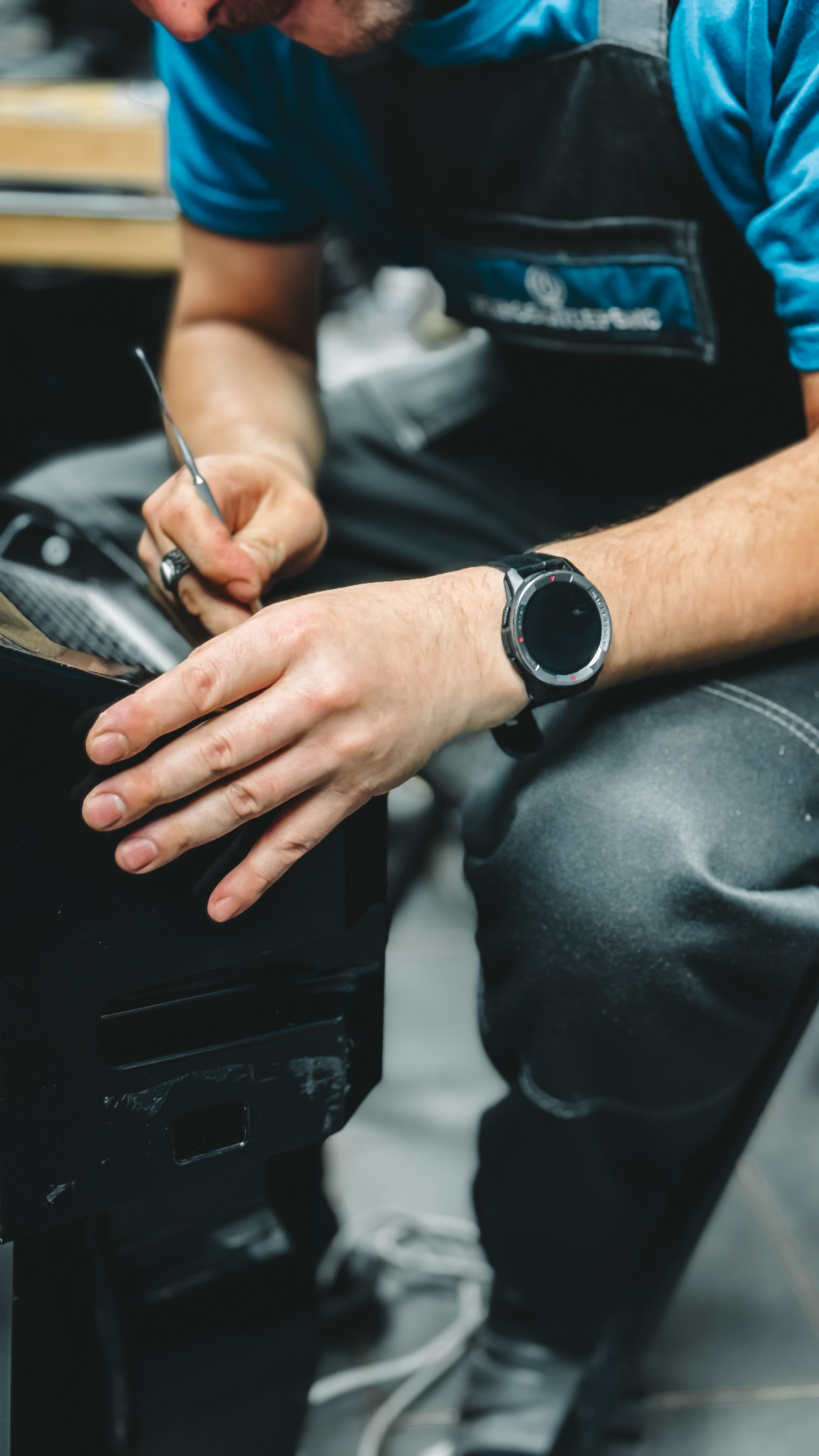 Detailed view of artisan hands crafting leather in a workshop.
