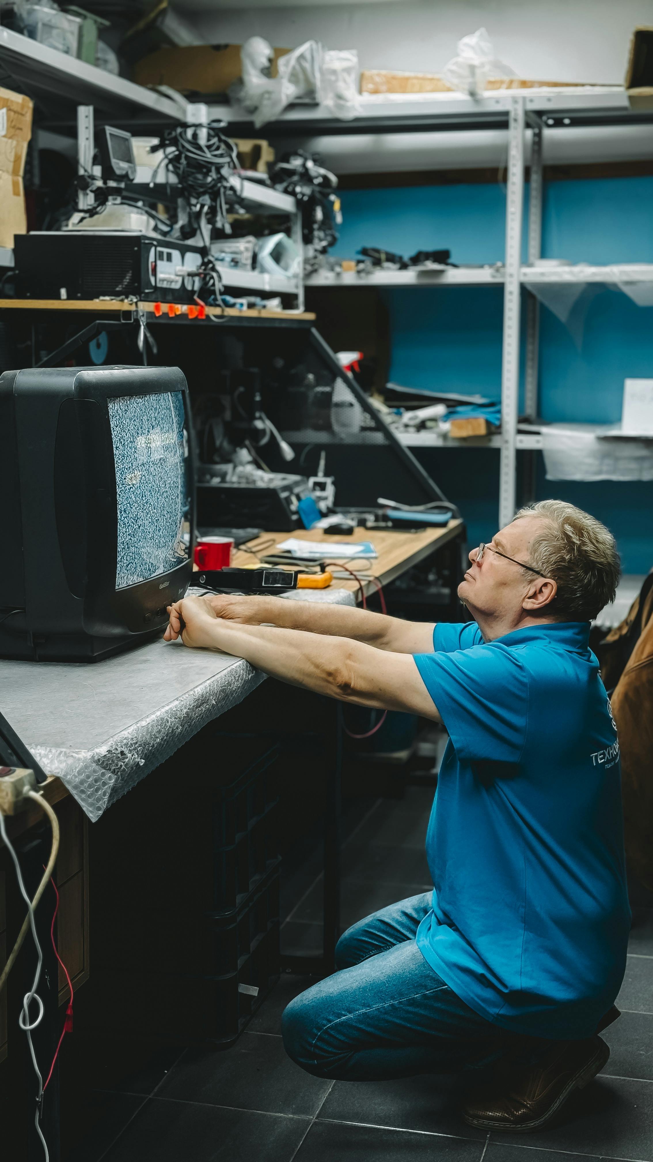 Technician repairing an old TV