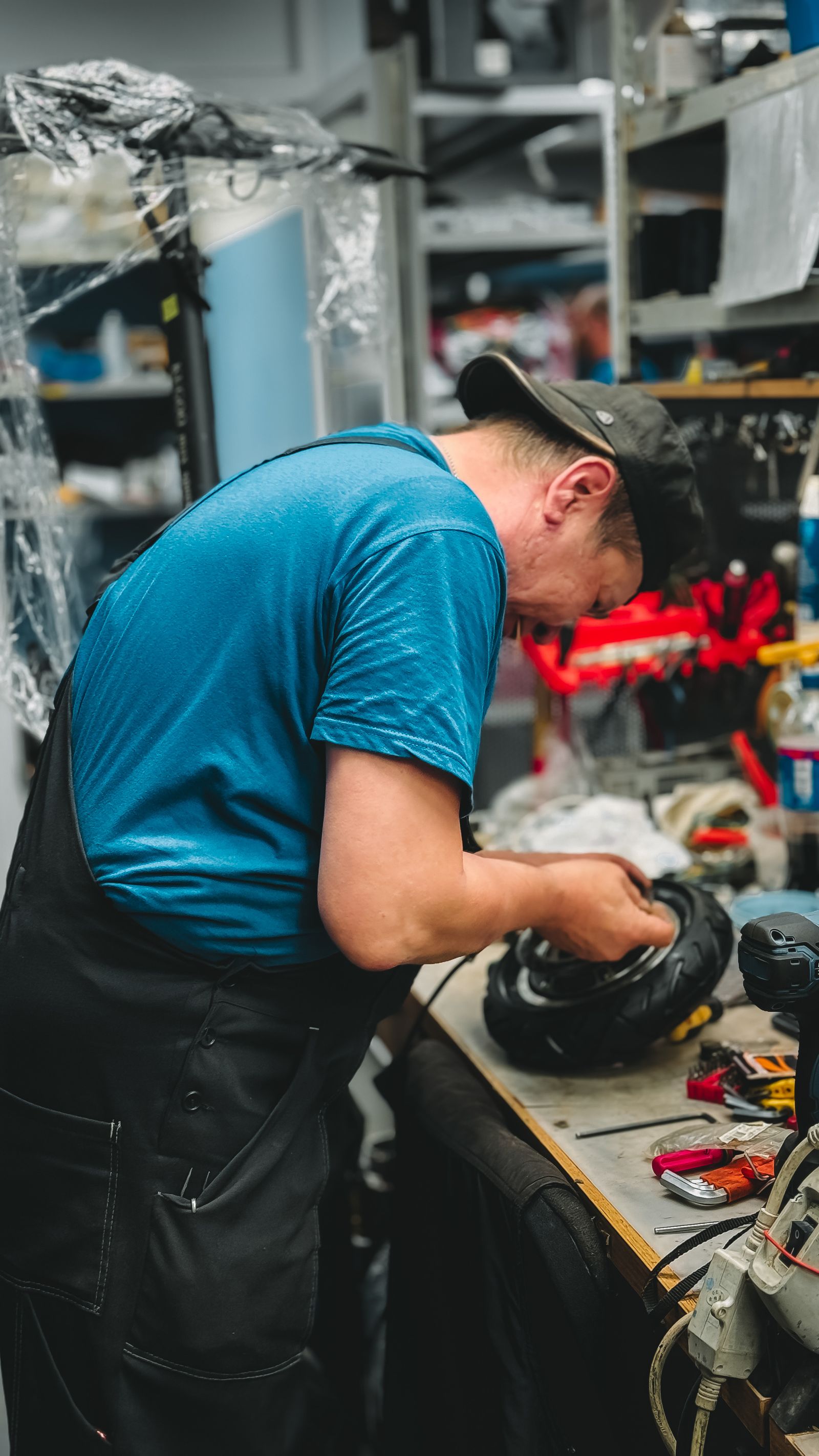 Mechanic repairing a tyre puncture on a workbench