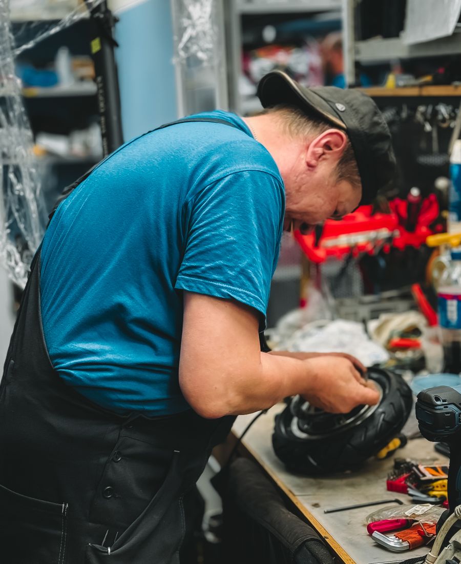 Mechanic repairing a tire on a workbench