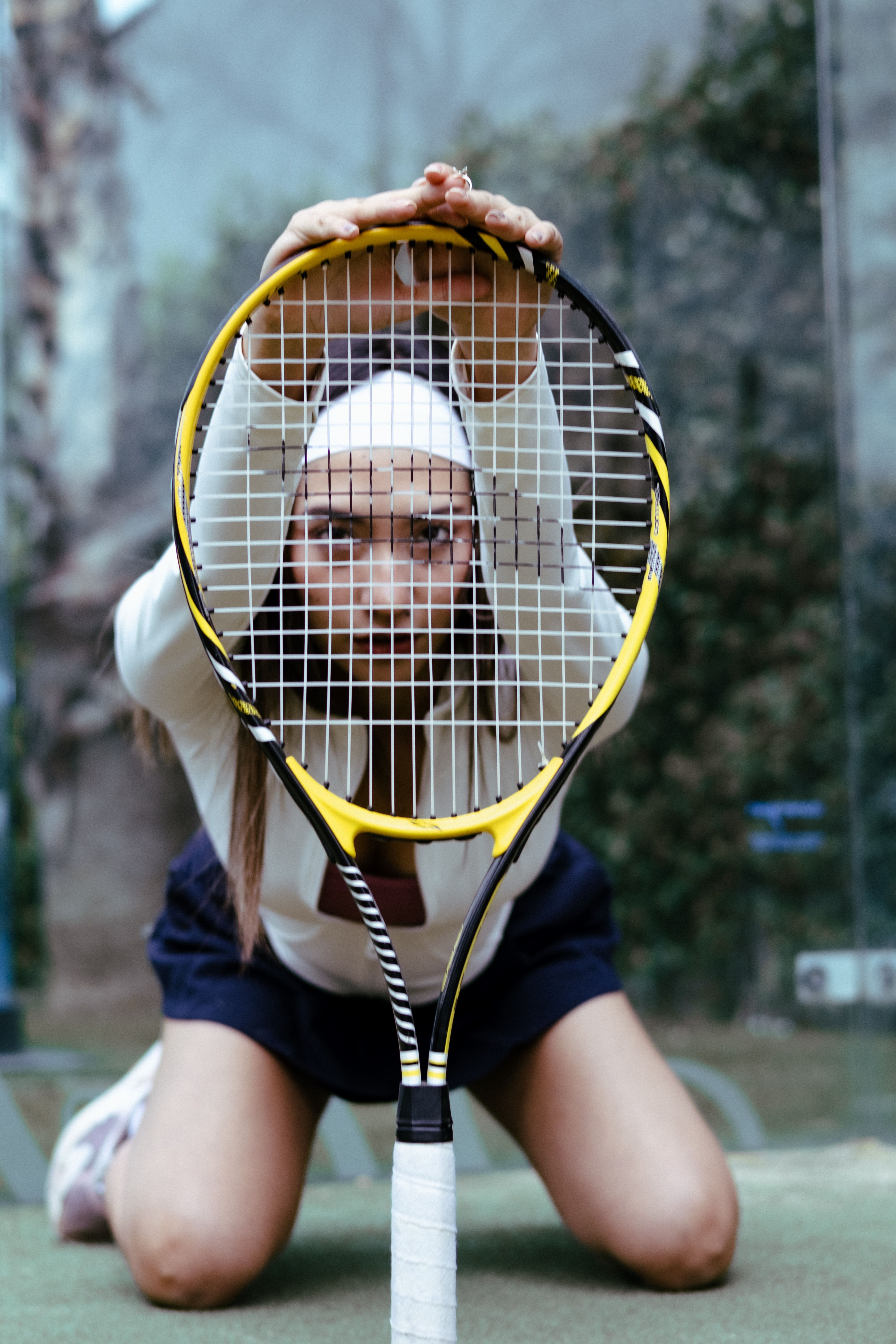 Woman Posing with Tennis Racket on Indoor Court · Free Stock Photo