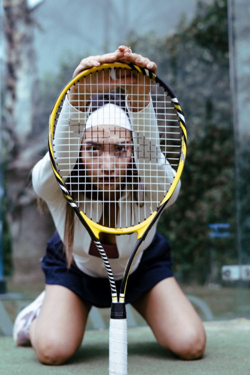 Photo Poses With Racket Woman Posing with Tennis Racket on Indoor Court · Free Stock Photo