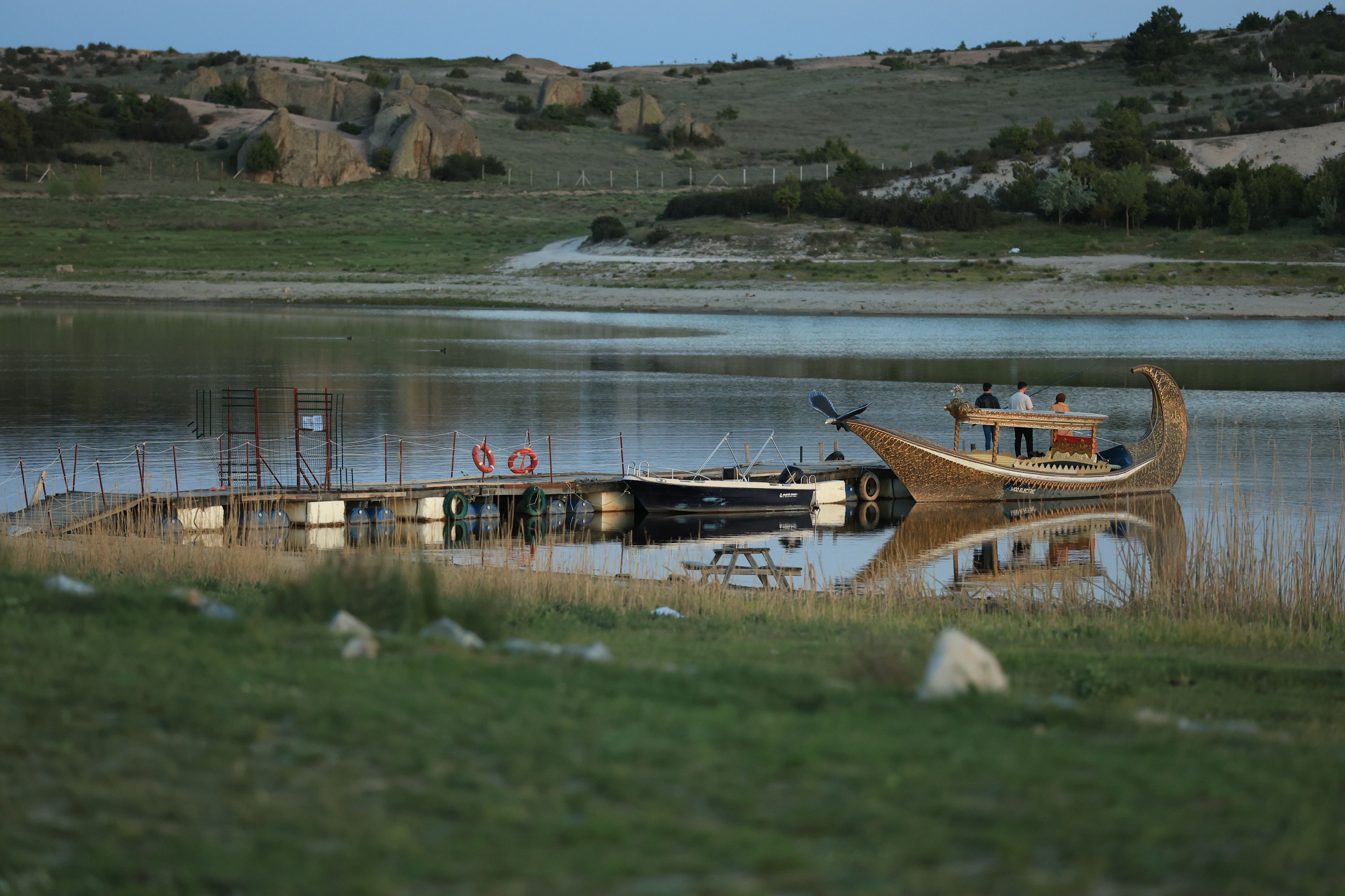 Scenic Lake View with Wooden Boat and Dock at Dusk · Free Stock Photo