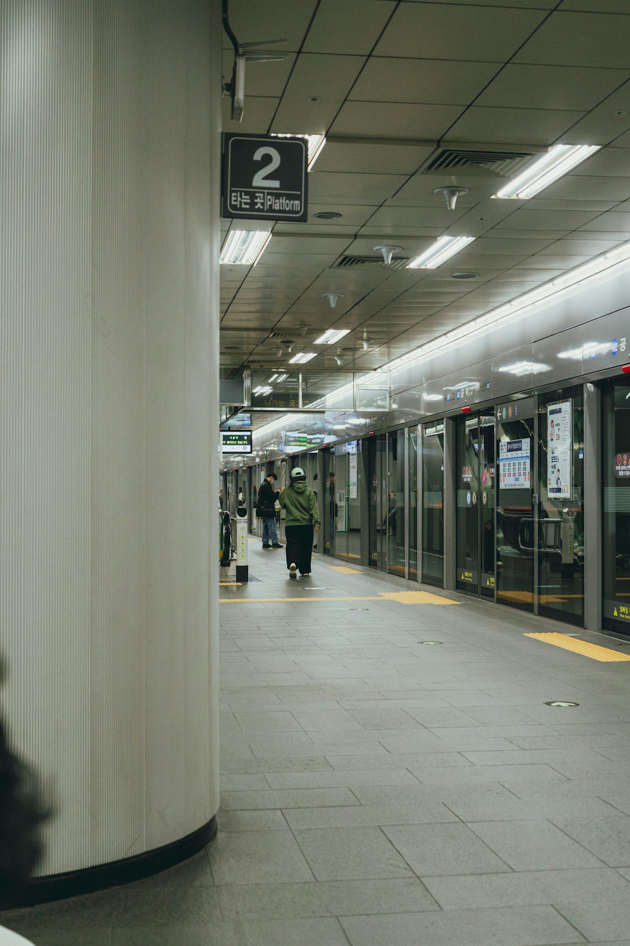 Seoul subway station platform with passengers waiting for the train