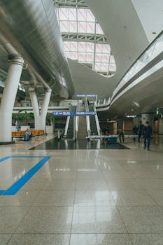 Wide view of Incheon International Airport terminal with escalators and travelers.