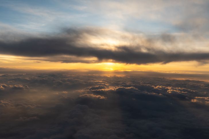 Sunrise above a layer of cloud seen from altitude. Photo by Robert Schwarz on Pexels.