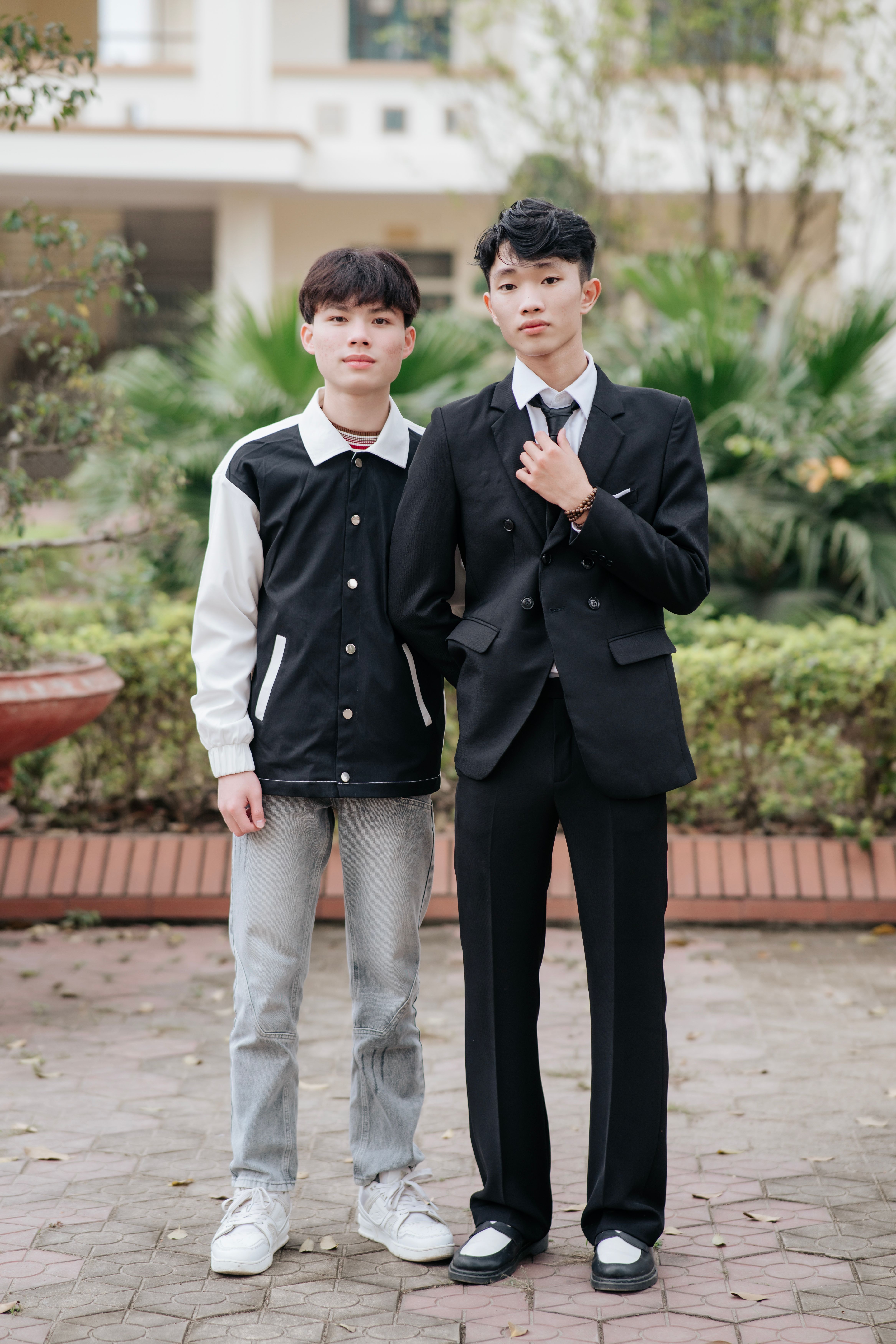 Two Young Men in Casual and Formal Attire Outdoors · Free Stock Photo