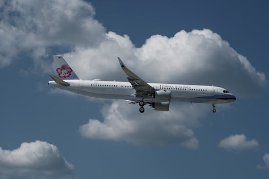 A China Airlines aircraft captured flying over Hamburg with a clear blue sky backdrop.