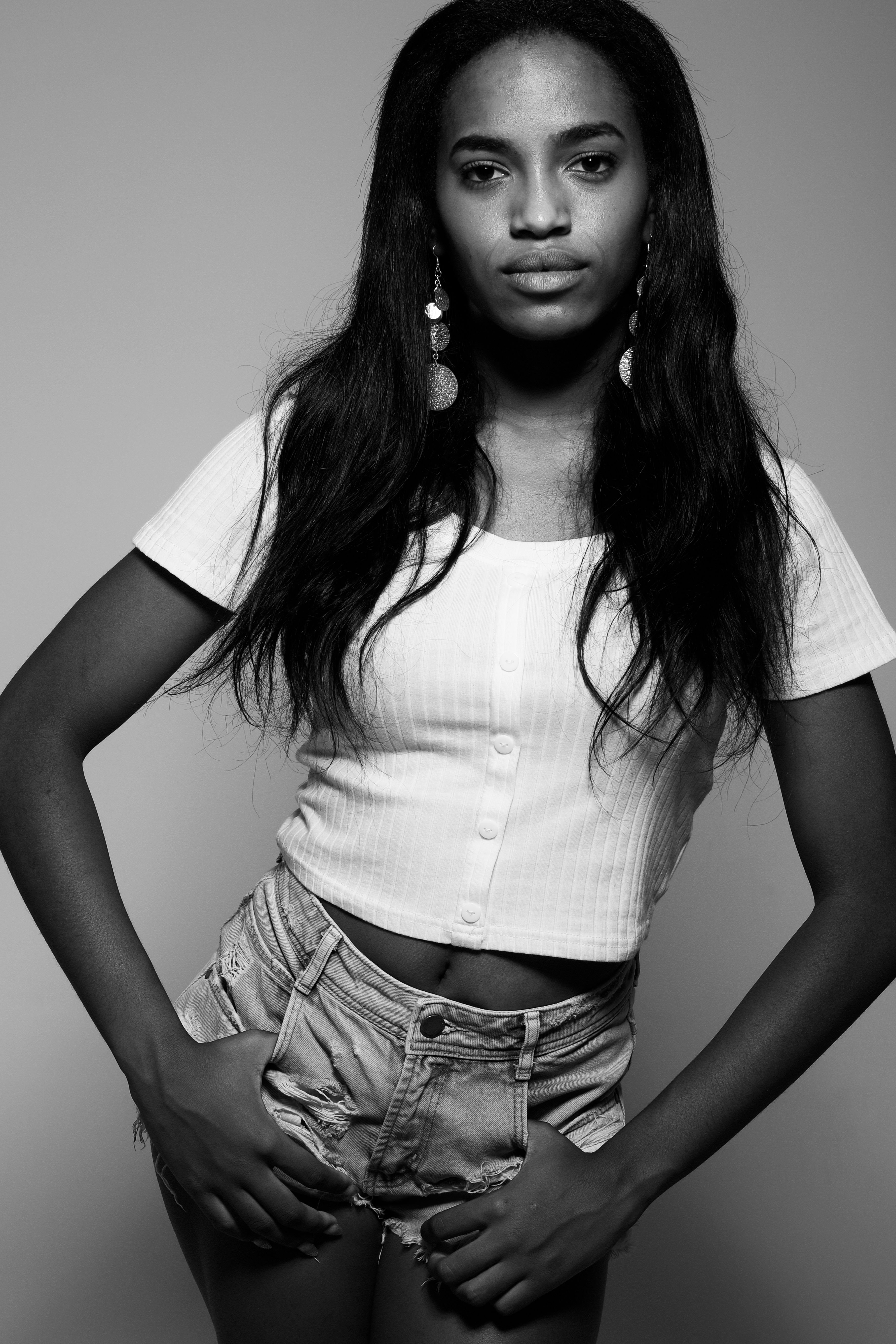 Elegant black and white portrait of a confident woman wearing casual attire.