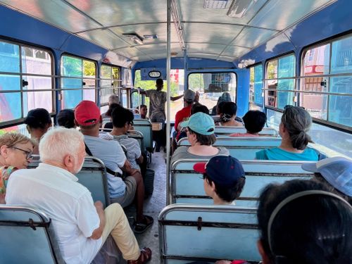 Free View from inside a bus with diverse passengers during daytime travel. Stock Photo