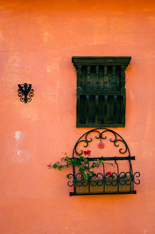 Free Vibrant colonial architecture in Boyacá, Colombia with an ornate window and flower basket. Stock Photo