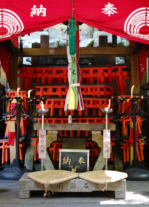 Free Vibrant Shinto shrine altar adorned with red torii gates and colorful cloth in Japan. Stock Photo