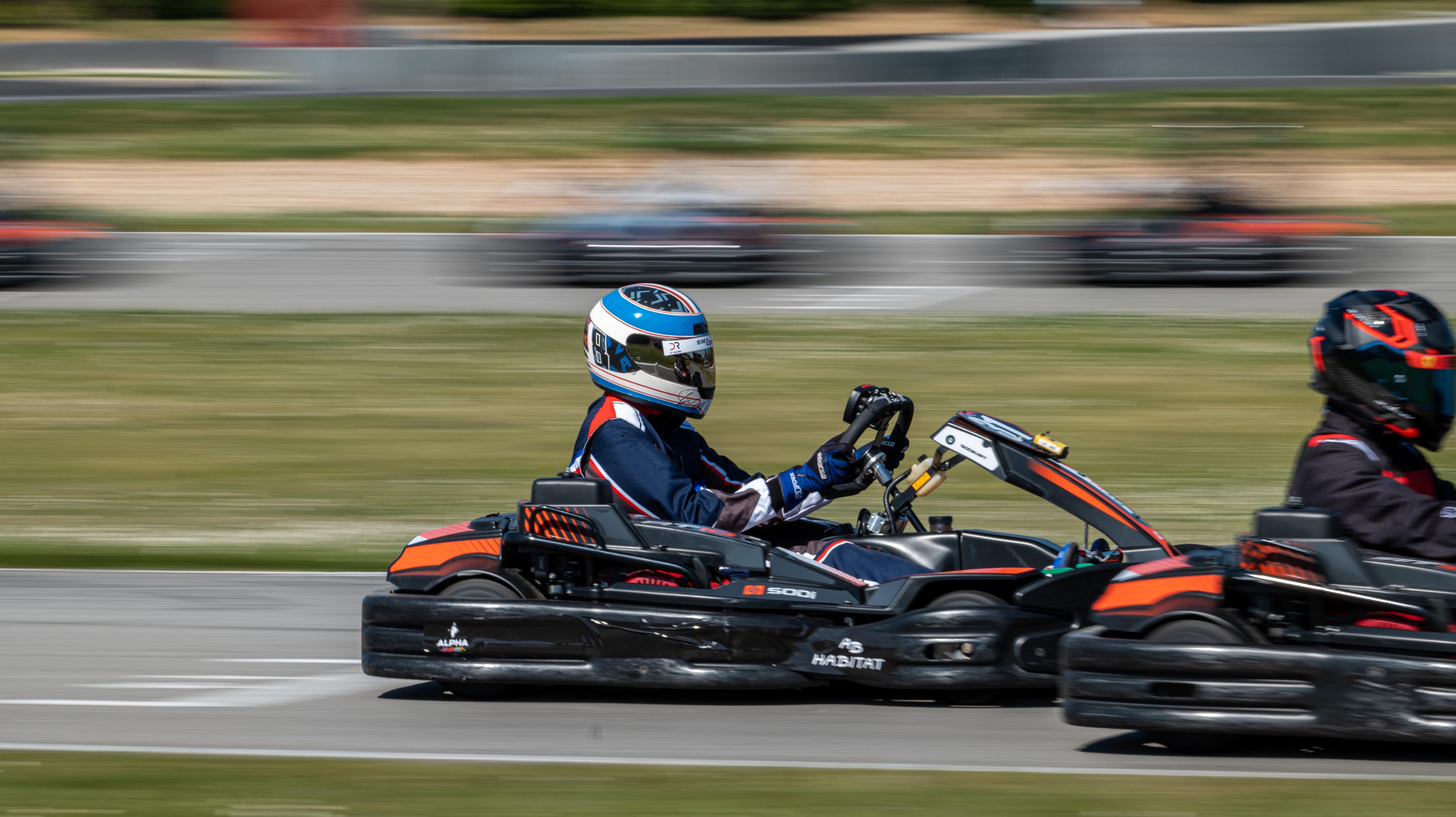 Dynamic Go-Kart Racing Action on Track · Free Stock Photo